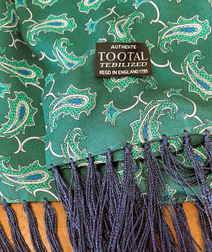Tootal green rayon scarf with classic paisley pattern and fringed ends, lightweight and double-faced for easy styling.