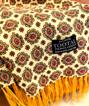 Tootal mellow yellow rayon scarf with medallion pattern and fringed ends, double-faced and lightweight.