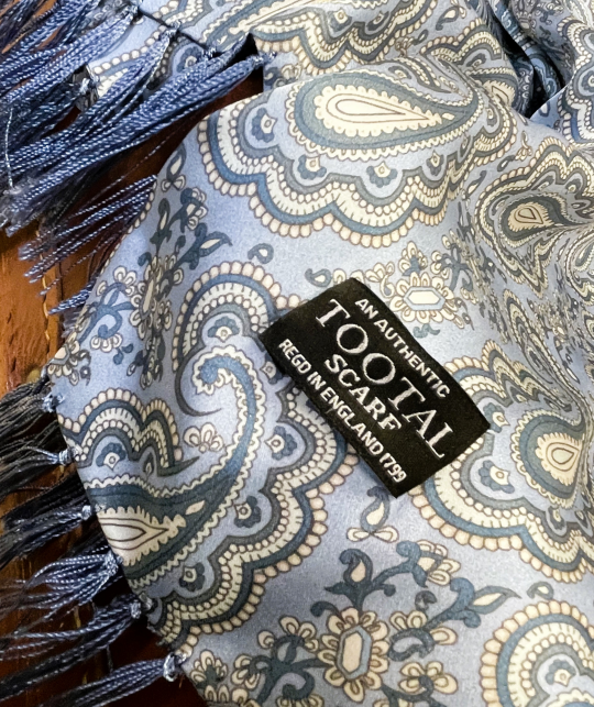 Tootal sky blue silk scarf with paisley pattern and fringe ends, made from 100% silk.