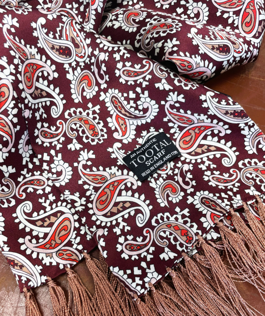 Tootal wine paisley silk scarf with fringe ends, double-faced and crafted from 100% silk.